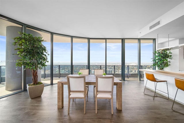 dining space featuring expansive windows and dark hardwood / wood-style floors