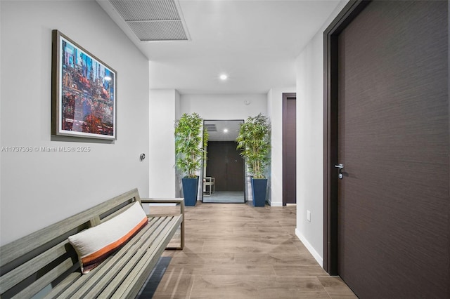 hall with light hardwood / wood-style floors