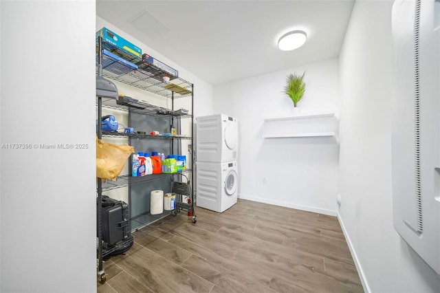 storage area featuring stacked washing maching and dryer