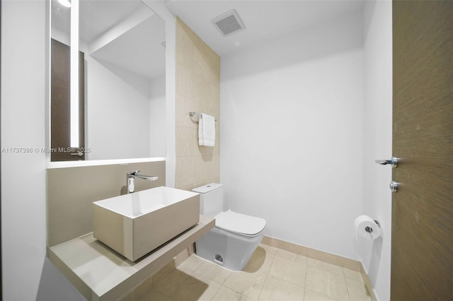 bathroom featuring sink, tile patterned floors, and toilet