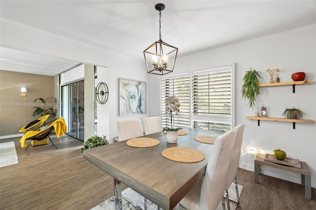 dining room with an inviting chandelier and dark hardwood / wood-style flooring