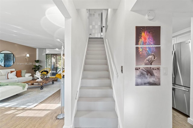 stairway featuring hardwood / wood-style floors