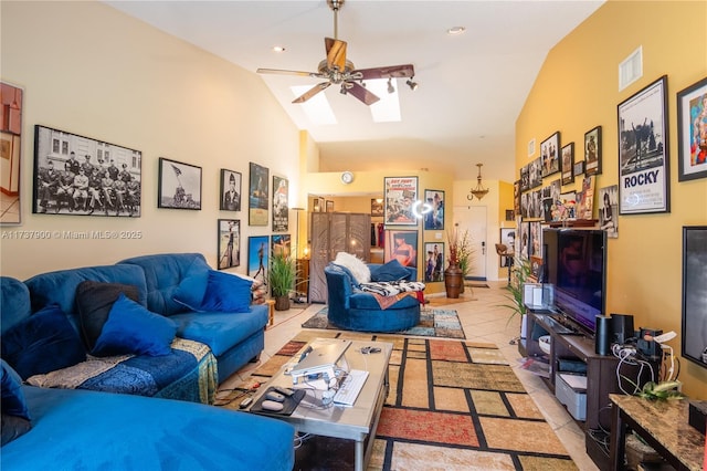 tiled living room featuring high vaulted ceiling, ceiling fan, and a skylight