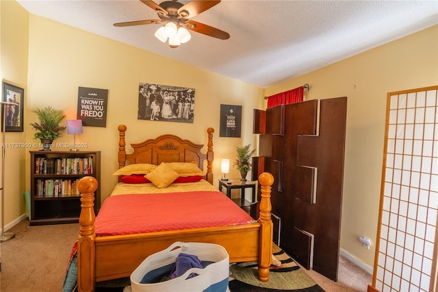 carpeted bedroom with lofted ceiling, ceiling fan, and a textured ceiling