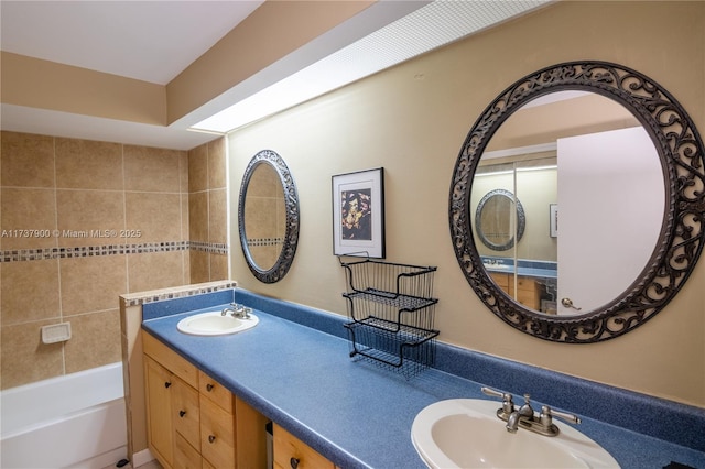 bathroom with vanity and a tub