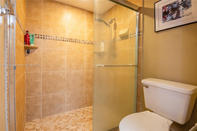 bathroom with an enclosed shower and toilet