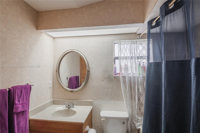 bathroom featuring vanity, toilet, and a shower with shower curtain