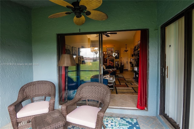 sunroom / solarium featuring ceiling fan