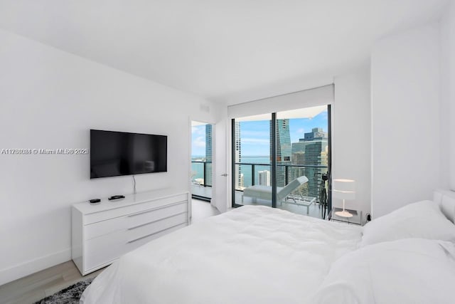 bedroom with access to outside and light hardwood / wood-style floors