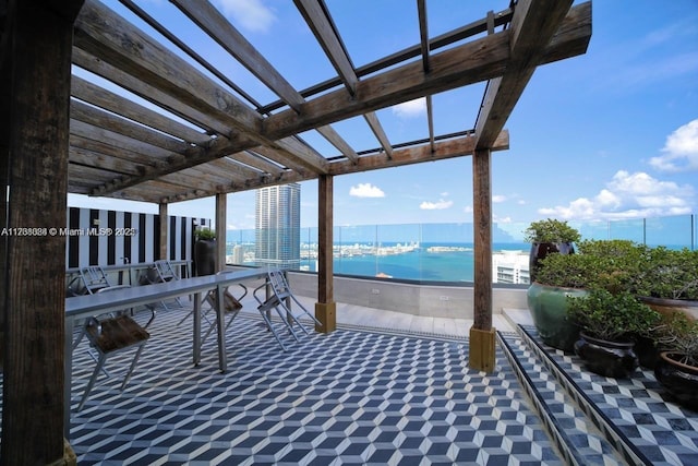 exterior space featuring a water view, a beach view, and a pergola