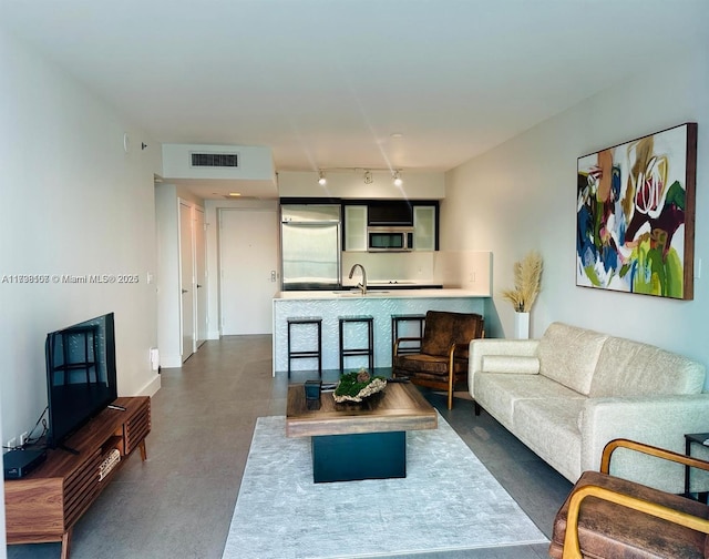 living room featuring sink and track lighting