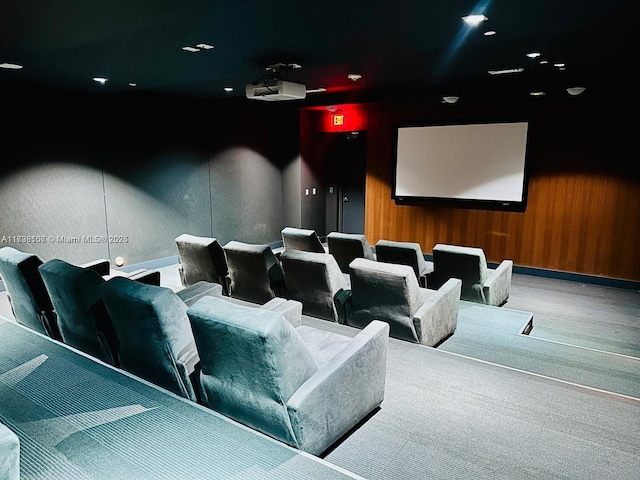 cinema with wood walls and carpet flooring