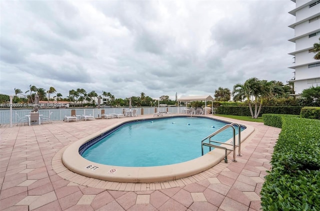 view of swimming pool with a patio