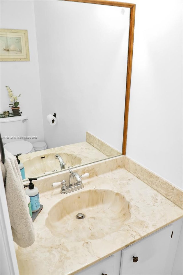 bathroom with vanity and toilet