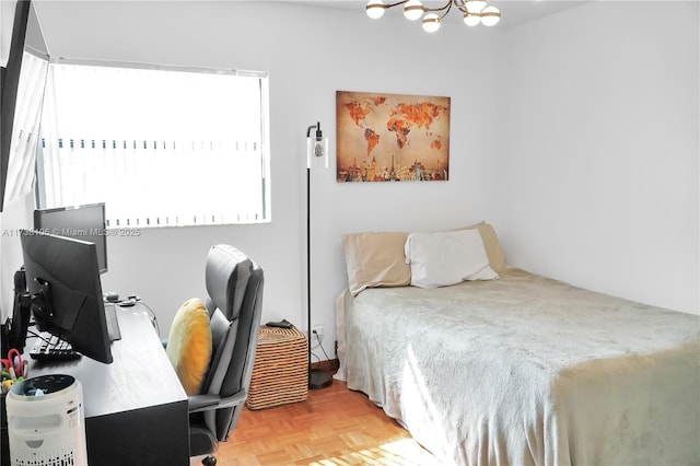 bedroom featuring a chandelier and light parquet flooring