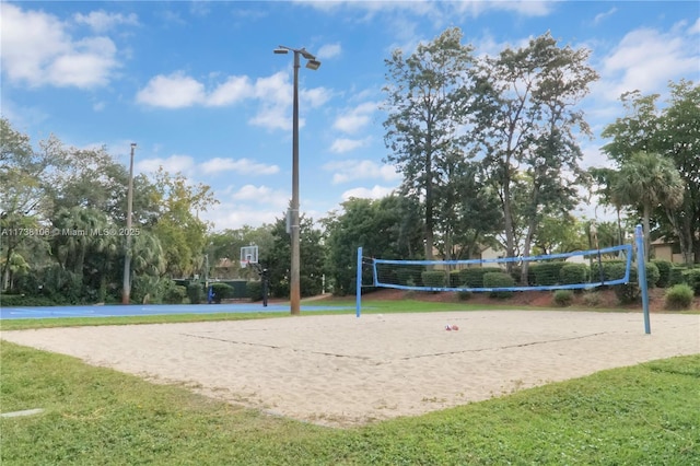 surrounding community featuring a yard and volleyball court