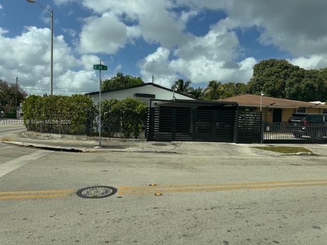 exterior space featuring a gate and a fenced front yard