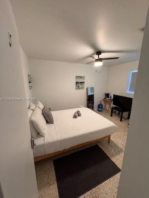 bedroom featuring a ceiling fan and speckled floor
