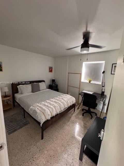 bedroom with ceiling fan and speckled floor
