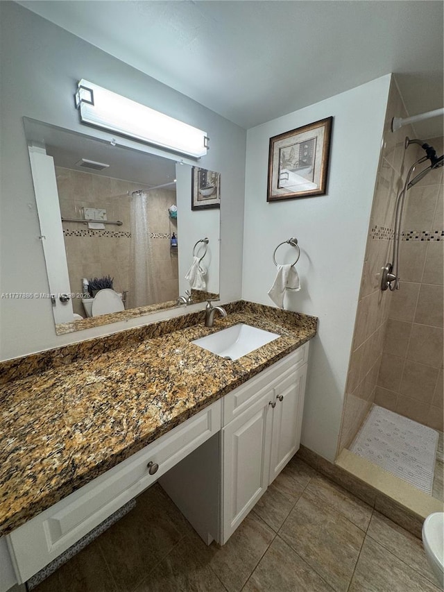 bathroom featuring vanity, toilet, tile patterned flooring, and a shower with shower curtain