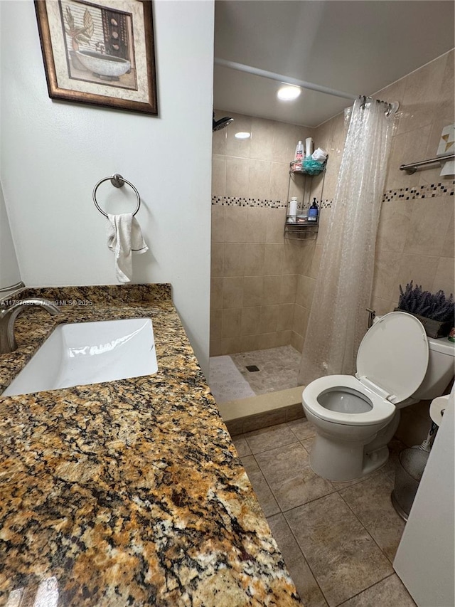 bathroom with tile patterned flooring, sink, toilet, and walk in shower