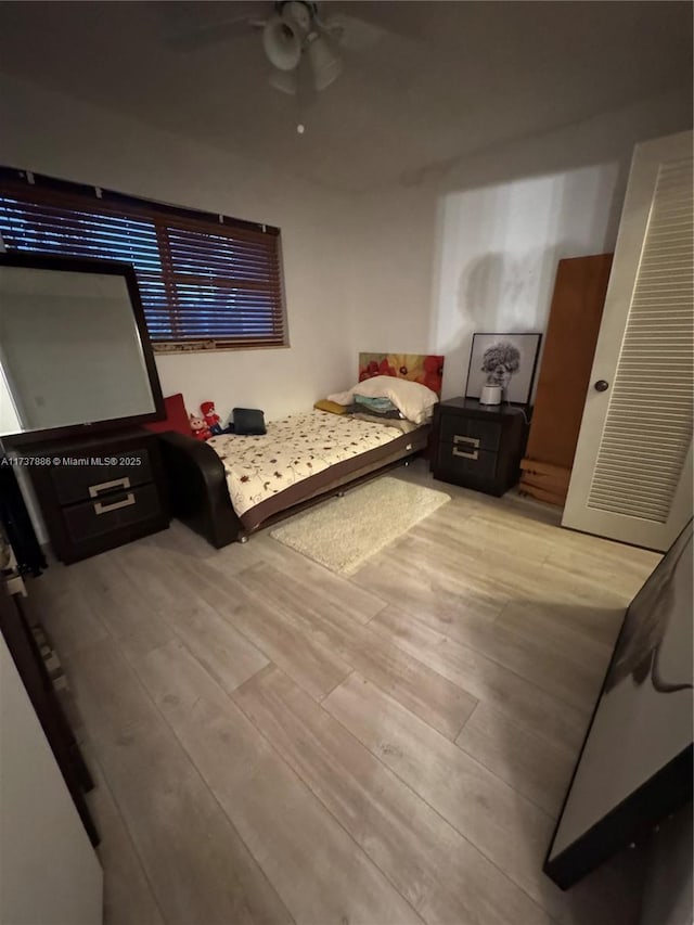 bedroom with ceiling fan and light wood-type flooring