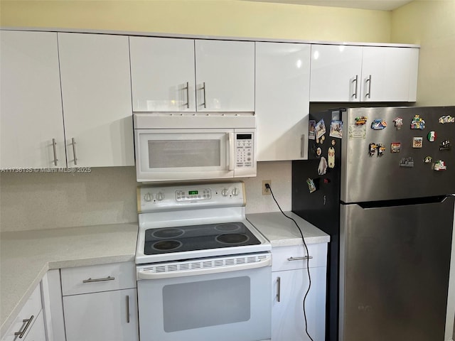 kitchen with light countertops, white appliances, and white cabinets