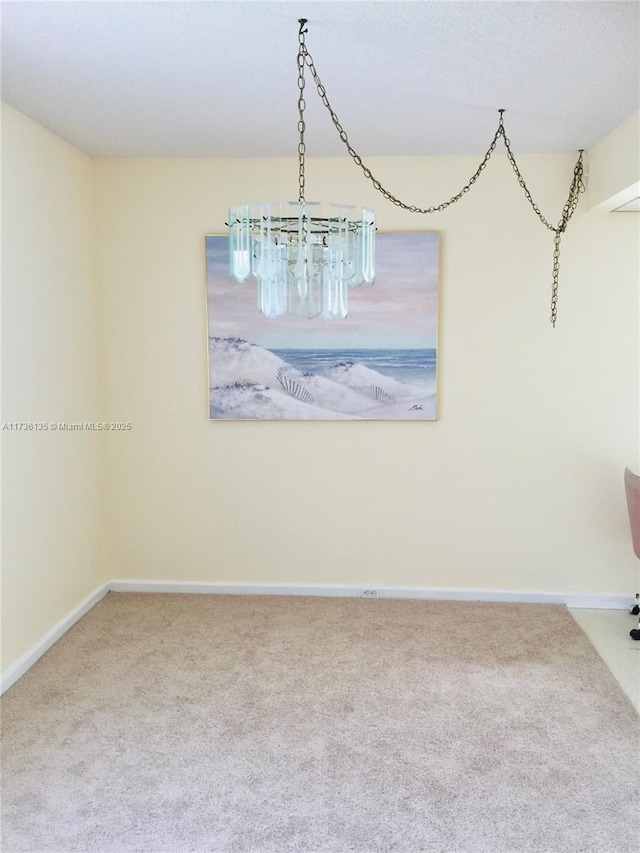 interior space featuring carpet and baseboards