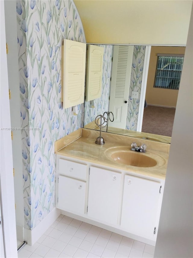 full bath featuring wallpapered walls, baseboards, and vanity