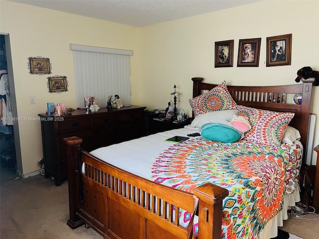 bedroom with carpet flooring and a textured ceiling