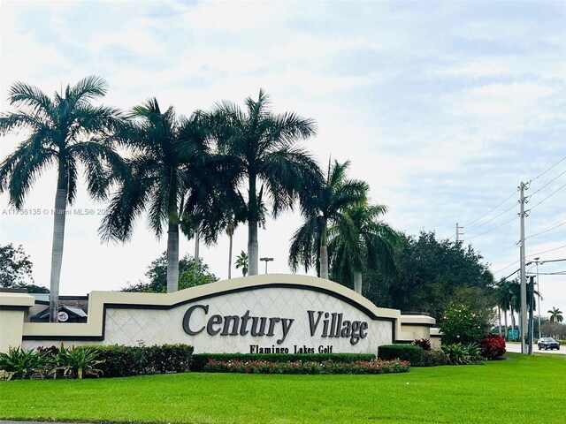 community / neighborhood sign with a lawn