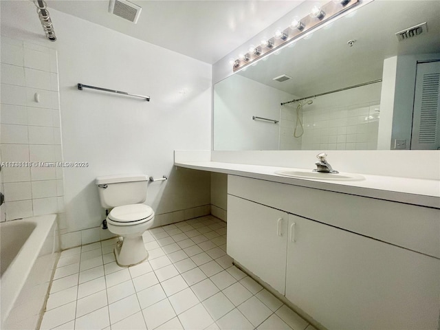 full bathroom with tiled shower / bath, vanity, toilet, and tile patterned flooring