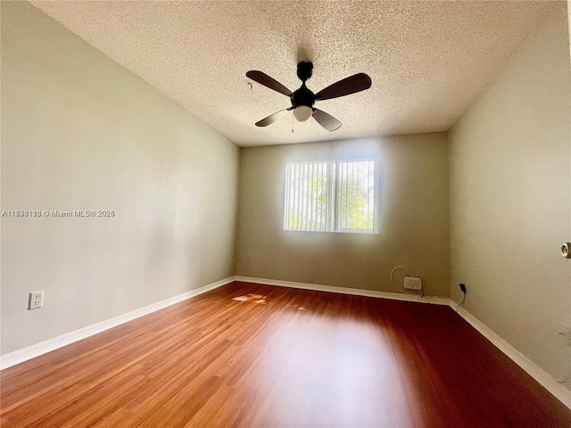 spare room with ceiling fan, hardwood / wood-style floors, and a textured ceiling