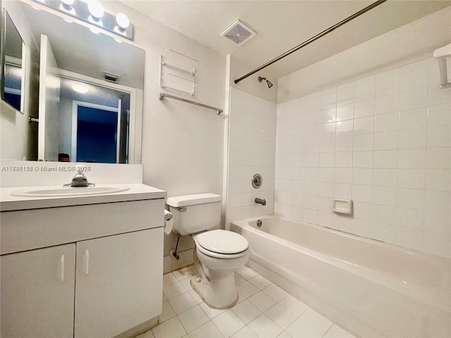 full bathroom featuring tiled shower / bath, vanity, toilet, and tile patterned flooring