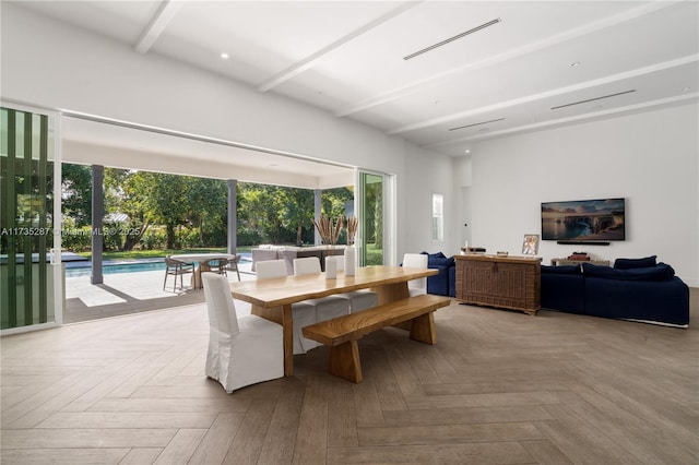 dining space with beamed ceiling and light parquet floors