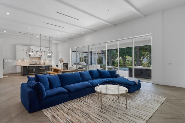 living room featuring light parquet flooring and beamed ceiling