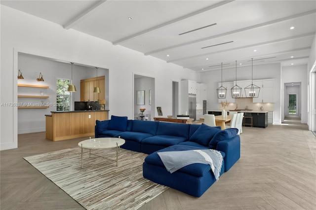 living room featuring light parquet flooring, a towering ceiling, and beam ceiling