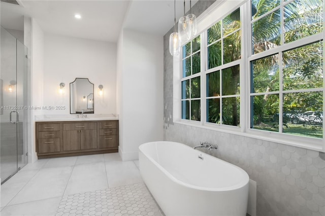 bathroom featuring tile patterned flooring, vanity, and separate shower and tub