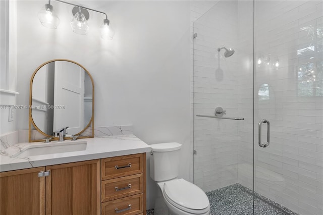 bathroom with vanity, an enclosed shower, and toilet