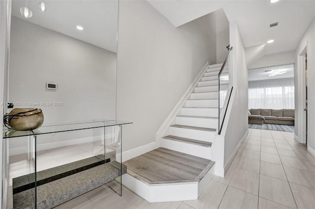 stairway with tile patterned floors