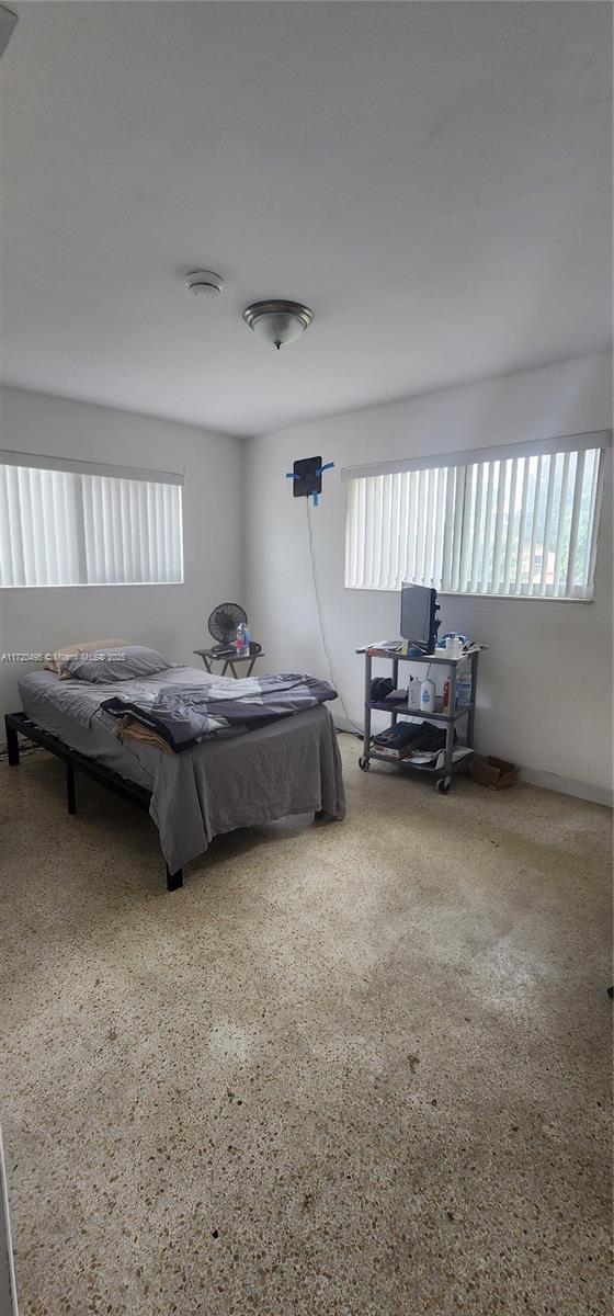 bedroom featuring multiple windows