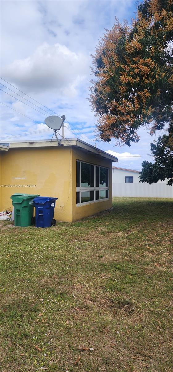 view of property exterior featuring a lawn