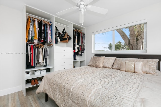 bedroom with ceiling fan and light wood-type flooring