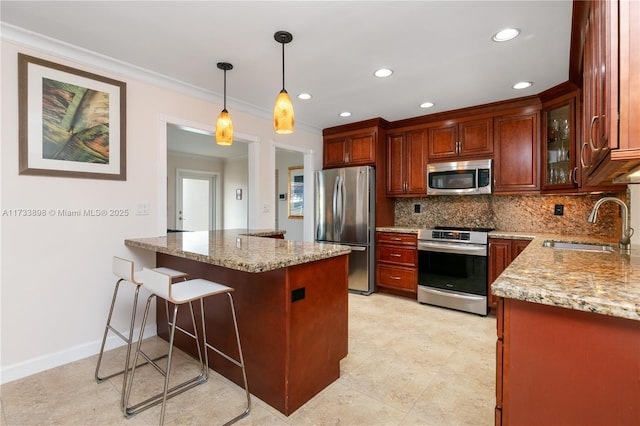 kitchen featuring sink, appliances with stainless steel finishes, kitchen peninsula, pendant lighting, and light stone countertops