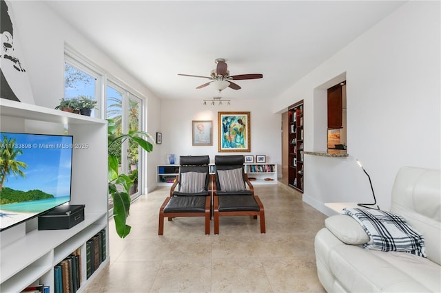 living room with light tile patterned flooring and ceiling fan