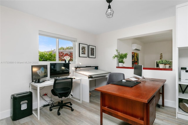 office featuring an AC wall unit and light hardwood / wood-style flooring