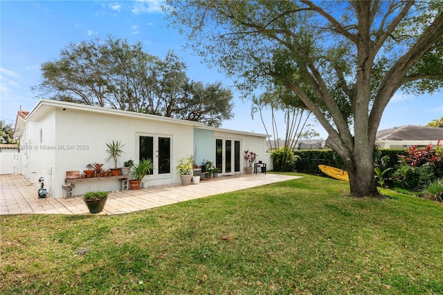 back of house featuring french doors, a yard, and a patio area