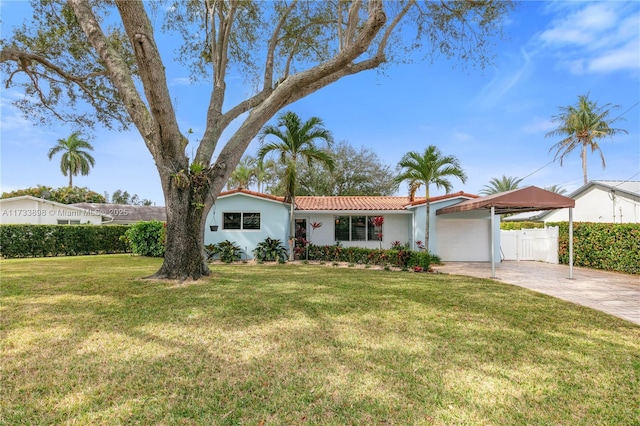 ranch-style home featuring a garage and a front yard