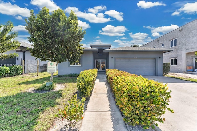 view of front facade featuring a garage and a front yard