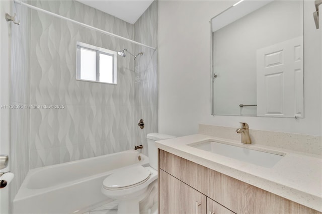 full bathroom with vanity, tiled shower / bath combo, and toilet